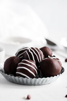 some chocolates are in a white bowl on a table