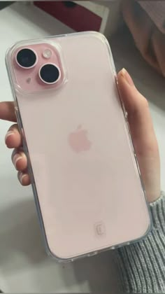 a person holding an iphone case with two buttons on the front and back cover in pink