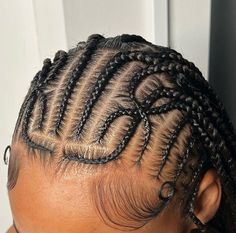 the back of a woman's head with cornrows