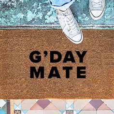 a door mat with the words g'day mate written on it next to a pair of shoes