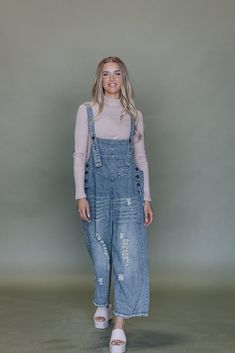 Frankie Denim Overalls are crafted from washed denim for a stylish, weathered look. Featuring an oversized and loose fit with adjustable straps and distressed details, these overalls are designed to provide a comfortable, personalized fit. Model Measurements: Hips 34” Waist 25” Bust 32” Height 5’6.5, wearing a size small Material: 100 Cotton Measurements XS: Hips: 42"| Length: 44" (taken from top of front of overalls to ankle cuff) S: Hips: 42"| Length: 44.5" (taken from top of front of overalls to ankle cuff) M: Hips: 46" | Length: 45" (taken from top of front of overalls to ankle cuff) L: Hips: 48" | Length: 45.5" (taken from top of front of overalls to ankle cuff) Casual Cotton Jeans With Suspenders, Denim Blue Washed Overall Jeans, Denim Blue Overalls With Frayed Hem, Medium Wash Denim Overalls With Suspenders, Washed Blue Denim Overalls, Medium Wash Denim Jumpsuits And Rompers, Distressed Overalls For Fall, Denim Jumpsuits And Rompers In Medium Wash, Denim Blue Jeans Overalls With Suspenders