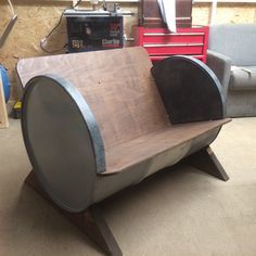 a wooden bench made to look like a barrel with some sort of seat on it