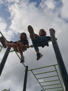 two children are playing on a swing set