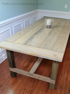 a wooden table sitting on top of a hard wood floor