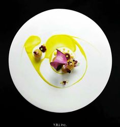 a white plate topped with food on top of a black table