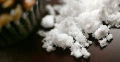 snow is piled on top of a wooden table