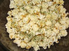 a glass bowl filled with popcorn sitting on top of a table