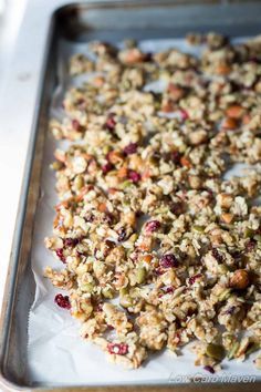 granola on a baking sheet ready to go into the oven