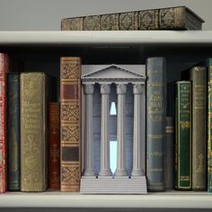 a book shelf filled with lots of books next to two stacks of books on top of each other