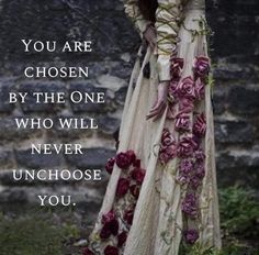 a woman wearing a long dress with flowers on it and the words you are chosen by the one who will never unchoose you