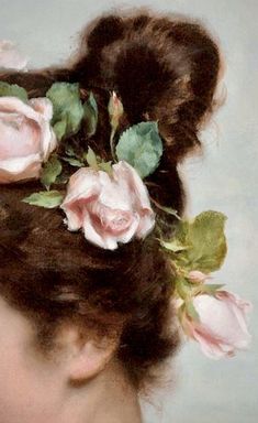 a close up of a woman with flowers in her hair