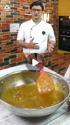 a man standing in front of a pan filled with food