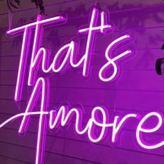 a purple neon sign that says that's amore