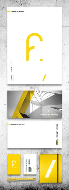 some yellow and white business cards on a concrete wall with the letter f in it