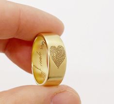 a fingerprint on a gold wedding ring is shown