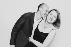 a man and woman are posing for a black and white photo with their arms around each other