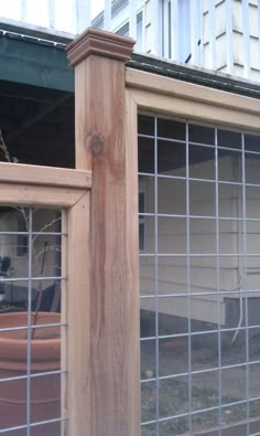 an outside view of a building with a fence around it and a potted plant in the window