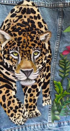 an image of a leopard painted on a jean jacket