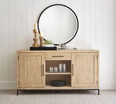 a wooden cabinet with a round mirror on top