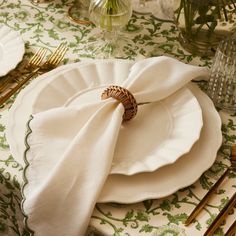 a white plate topped with a napkin on top of a table