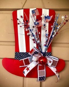 a patriotic red white and blue decoration hanging on a door