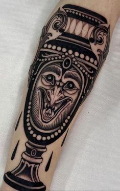 a man's arm with a black and white tattoo design on it, including an ornate