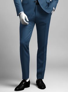 Bring some classic dignity, sophisticated style and warm touch to your work week wardrobe with our Napolean Casa Blue Wool suit. Crafted from wool blend, a long been piece with remarkable comfort and feel which complements the incredible versatility offered by its blue hue. Wear it with a matching waistcoat, a crisp white shirt, dotted light blue tie and brown dress shoes.  Look Includes   Napolean Casa Blue Wool Fabric  Two Button Jacket Style  Notch Lapel  Horn Royal Black Buttons  Single Vent  Three Cuff Buttons  Two Welted Back Pockets on Trousers    Click 'Customize Now' to modify the look if needed.   Lining: Viscose, Dry Clean, Pants can be lightly washed. Grey Tweed Suit, Fabric Cross, Herringbone Tweed Jacket, Light Blue Tie, White Linen Suit, Brown Dress Shoes, Green Velvet Jacket, Peaky Blinders Suit, Royal Blue Suit