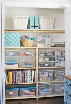 an organized closet with plastic bins, baskets and other crafting supplies on shelves