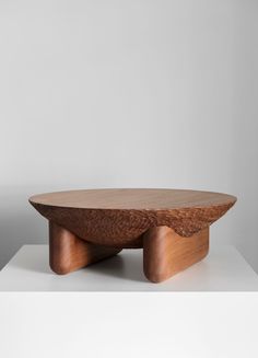 a wooden coffee table on top of a white surface