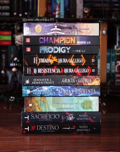 a stack of books sitting on top of a wooden table