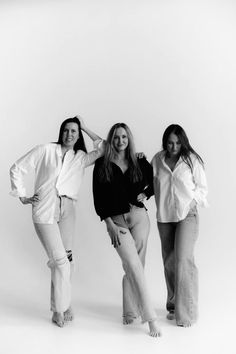 three young women posing for a black and white photo with their arms around each other