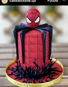 a spider - man cake is sitting on top of a table