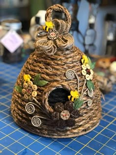 a basket with flowers and buttons on it sitting on top of a blue tablecloth