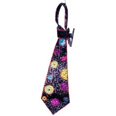 a tie that is hanging from a hook on a white background with colorful circles and dots