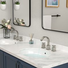 a bathroom with two sinks and mirrors on the wall next to it is decorated with flowers in vases