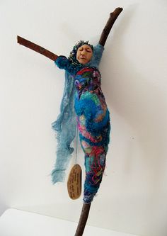 an image of a doll hanging on a stick