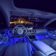 the interior of a car with blue lights