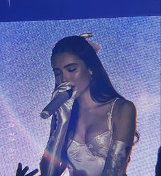 a woman in white dress holding a microphone