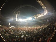 an audience at a concert is seen through a fish eye lens