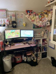 two computer monitors sitting on top of a desk in front of a cat laying on the floor