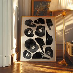 an image of new york yankees hats in a frame on the floor next to a lamp