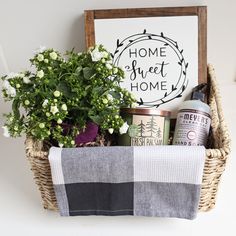 a basket filled with lots of different items next to a sign that says home sweet home