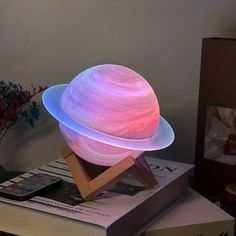 an illuminated object on top of a stack of books