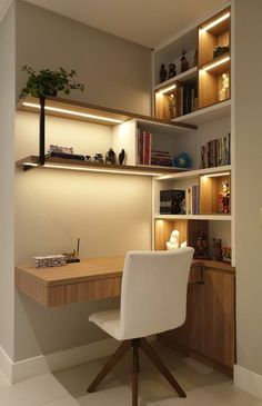 a desk and chair in a room with bookshelves on the wall behind it