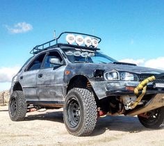 an off - road vehicle parked in the desert with no wheels on it's tires