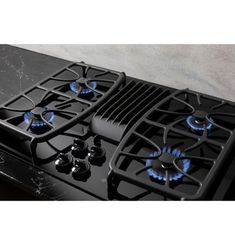 a black stove top with blue burners and knobs on it's side