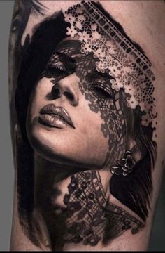 a woman's face with lace on her head is shown in this black and white tattoo