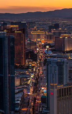 an aerial view of the las vegas strip at night with skyscrapers and hotels in the background