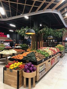 the produce section of a grocery store with fresh fruits and vegetables