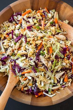 a wooden bowl filled with coleslaw and carrots